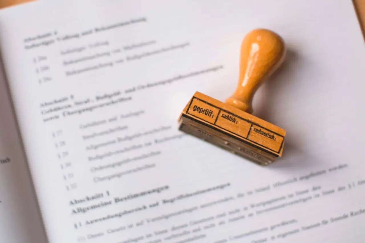 Tampon encreur en bois posé sur un document juridique allemand imprimé